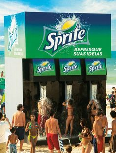 a group of people standing in front of a sprite water dispenser