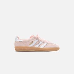 Women's Gazelle Indoor silhouette Suede upper Padded collar T-toe detail Textured tongue  Tri-Stripes on lateral sides  Gazelle gold foil branding on lateral sides  Flat woven laces Leather heel counter Gum rubber outsole   Style: aaih5484 Color: Sandy Pink / White / Gum 3 Material: Leather Light Pink Adidas Gazelle, Back To School Shoes Adidas, Adidas Shoes Women Pink, Light Pink Adidas Campus, Cute Popular Shoes, Pink And White Sambas, Light Pink Sambas, Gazzels Shoes, Colored Sambas