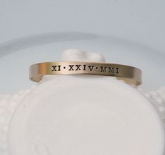 "CURRENT TURNAROUND TIME IS THREE (3) WEEKS ~Personalized Roman Numeral Cuff Bracelet - Special Date Bracelet - Engraved Custom Date Bracelet - Stacking Bracelet - Gift for Her '*.'*.'*.¸What You Will Receive ¸.*''.*''.*'' ❤ One (1) 1/4\" x 6\" brass cuff bracelet with brushed finish ❤ Items will be sent in clear cellophane bags. Boxes/gift packaging can be added at checkout for an additional fee. ❤ '*.'*.'*.¸What I Need To Complete Your Order ¸.*''.*''.*'' (enter the below info in the \"Note\" Adjustable Stackable Cuff Bracelet For Anniversary, Gold Adjustable Stamped Cuff Bracelet, Adjustable Stamped Gold Cuff Bracelet, Adjustable Gold Stamped Cuff Bracelet, Personalized Gold Cuff Jewelry, Nickel Free Cuff Bangle As Gift, Nickel-free Cuff Bangle As Gift, Nickel Free Cuff Bracelets As A Gift, Customizable Adjustable Vintage Jewelry