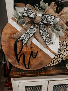 the monogrammed wooden sign is decorated with leopard and cheetah print ribbon