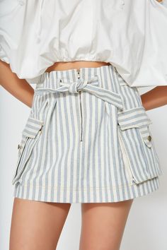 Equally chic and versatile, our denim skirt is woven from upcycled cotton into a vintage blue and white stripe without the use of toxic chemicals. Designed to sit high on your waist with a paperbag look, this style fastens with a center-front zip and a built-in belt to cinch the waist as desired. This mini skirt has an A-line cut with functional cargo pockets. Pair with sandals, white sneakers and booties for picnic-perfect days, beach walks or road trips. It’s an everyday staple. This item is m Denim Skirt Outfits Summer, Skort Outfit, Skirt Outfits Summer, Perfect Days, Denim Skort, Beach Walks, Denim Skirt Outfits, Vintage Blue And White, Toxic Chemicals