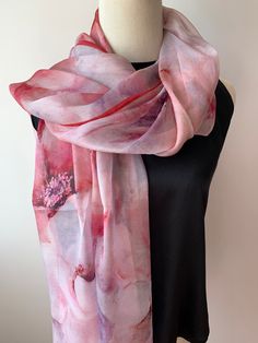 Large long natural mulberry silk chiffon scarf with dimension of 180cm x 110 cm/ 71in x 43in. A watercolor styled print, with a soft blend of pinks and reds. The gorgeous flowers and the flowy petals bring a delightful feel of gentleness, and the dark red border ties the print together. Light weight, soft and sheer fabric, airy, breathable, and skin-friendly feels very comfortable to wear.  It's a beautiful addition to your outfit and can style it in different ways: drape it over shoulder and tie it as a shawl, wear the scarf as a soft neck scarf, as an evening cover up, as a head scarf, as an outdoor cover up or style it any way you want with your own sense of creativity... Suitable for all seasons and is a wonderful  gift idea for special occasions. Care Instructions: Pure silk is a type Silk Neck Scarf, Silk Chiffon Scarves, Chiffon Shawl, Chiffon Wrap, Red Border, Gorgeous Flowers, Outdoor Cover, Scarf Silk, Wedding Shawl