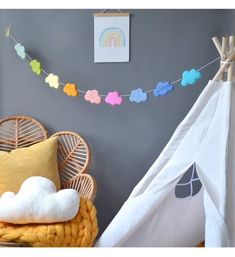 a child's room with a teepee and pillows