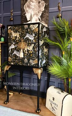 a chair with an animal print on it next to a potted plant and other items