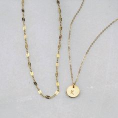 Two of our best selling necklaces in one set! Choose gold filled or sterling silver. Perfect for your everyday tee shirts, makes a wonderful gift too. -Set of two necklaces -Top Layer is a chain style in your choice -Bottom Layer Disc Necklace -Petite disc measures 10mm -Choose 14kt Gold-Filled or Sterling Silver -A high quality delicate link chain. -Polished to a light satin finish. CUSTOM HAND STAMPING -Hand stamped in classic block font with an initial. -Your choice of text up to 3 letters on Everyday Hypoallergenic 14k Gold Charm Necklace, Gold Circular Charm Necklace With Adjustable Chain, Minimalist Coin Necklace With Delicate Chain For Everyday, Gold Hypoallergenic Round Pendant Jewelry, Everyday Minimalist Coin Necklace With Delicate Chain, Everyday Hypoallergenic Yellow Gold Charm Necklaces, 14k Gold-filled Chain Necklace For Gift, Everyday Round Disc Gold Plated Necklace, 14k Gold-filled Chain Necklace With Round Shape As Gift