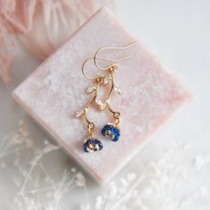 "Blue Flower Earrings // Gold Filled Earrings // Boho Bridal Earrings // Floral Earrings // September Birthstone // Birth Flower // Sapphire Blue // Birthday Gift // Gift for Mom // Bridesmaids Earrings :: If searching for, \"something blue,\" for your wedding let these floral earrings provide a little pop of color to your special day.  These sapphire blue flower earrings are a delicate and feminine design perfect for any boho wedding attire or for adding a little sparkle to your next special occasion. The tiny navy blue flower petals are created with faceted glass and secured to golden stems featuring small cubic zirconia leaves. The wild flower earrings are light weight and suspended from comfortable 14k gold filled earrings. Whether adding these flower earrings for a lovely touch of col Delicate Blue Flower Earrings With Ear Wire, Blue Flower Earrings With Ear Wire For Party, Dainty Blue Drop Earrings, Blue Drop Earrings With Flower Charm, Elegant Blue Drop Earrings With Flower Charm, Delicate Blue Flower Shaped Earrings, Delicate Blue Flower Earrings, Delicate Blue Flower-shaped Earrings, Elegant Blue Birth Flower Earrings