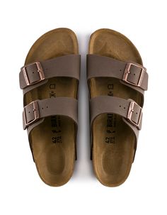 Birkenstock Arizona Sandals. The often imitated, never duplicated, category-defining, two-strap wonder from Birkenstock. A comfort legend and a fashion staple. With adjustable straps and a magical cork footbed that conforms to the shape of your foot, a truly custom fit is as effortless as the classic design. -Narrow width (fits like a US medium width) -Birkibuc – a durable, synthetic upper material with a nubuck leather-like texture and a soft backing -Contoured cork footbed conforms to the shap Birkenstock Arizona Mocha, Birkenstock Style, Birkenstock Men, Dr Shoes, Birkenstock Sandals Arizona, Simple Sandals, London Shoes, Birkenstock Sandals, Birkenstock Arizona