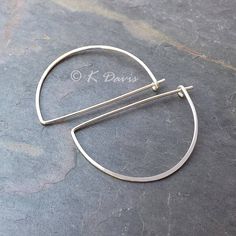 Modern silver hoop earrings in a unique half moon style. A classic hoop with flair! Formed from solid sterling silver wire these half circle earrings have been hammered to emphasize the curve of the hoop. Then lightly sanded and polished to give them a nice shine. These sterling silver hoops measure in at about 1.25 inch (see photo in listing). Made from 20 gauge (.81mm thick) solid sterling silver wire. 20 gauge is the standard size for most lightweight hoops. You can enter my shop here: http:/ Minimalist Half Moon Earrings For Everyday, Minimalist Sterling Silver Hoop Earrings With Moon Charm, Modern Silver Semi-circle Jewelry, Modern Crescent Hoop Earrings For Everyday, Hoop Earrings With Moon Charm, Modern Nickel-free Open Circle Hoop Earrings, Round Metal Hoop Earrings With Moon Charm, Metal Hoop Earrings With Moon Charm, Minimalist Crescent Hoop Earrings With Ear Wire