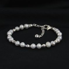 You'll love our gray pearl bracelet for its dainty design and hint of sparkle! We've paired these pearls with sterling mirror beads for a beautiful shine. This bracelet is a great quality gift! ABOUT: * Materials: sterling sliver lobster claw and sterling silver 1.5 inch extension * Beads: freshwater pearl, sterling beads * Width: 5mm SHOP OUR BRAND > https://rosaperlina.etsy.com WHAT IS STERLING SILVER? * Sterling silver is a mix of 92.5% of silver and 7.5% of other metals, typically copper. * Everyday Silver Beaded Bracelet With Pearl Charm, Dainty Silver Bracelet With Pearl Chain, Everyday Silver Bracelets With Pearl Chain, Adjustable Pearl Necklace With Silver Beads, Minimalist Silver Pearl Chain Bracelet, Silver Pearl Bracelet With Pearl Drop As Gift, Silver Pearl Bracelet With Pearl Drop For Gift, Silver Pearl Drop Bracelet As Gift, Dainty Silver Bracelet With Pearl Drop