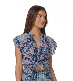 The Ginger Printed Blouse is a versatile and stylish addition to any wardrobe. Its mesmerizing floral print adds a touch of elegance to any outfit, making it the perfect choice for any occasion. This short-sleeved blouse is designed to be a universal fit, ensuring that it looks great on anyone. It is available in two beautiful colors, blue and pink, allowing you to choose the one that best suits your personal style. Made from 100% Indian cotton, this blouse is not only fashionable but also comfo Printed Short Sleeve Tops For Day Out, Feminine Short Sleeve Tops For Beach, Feminine Short Sleeve Beach Tops, Floral Print Rayon Short Sleeve Tops, Bohemian Style Short Sleeve Blouse With Floral Print, Short Sleeve Floral Print Rayon Top, Bohemian Short Sleeve Blouse With Floral Print, Short Sleeve Rayon Tops With Floral Print, Casual Short Sleeve Floral Print Blouse