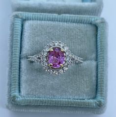 Beautiful pink sapphire diamond ring set in 18K White Gold. Excellent craftsmanship on this ring. The diamonds are all white and super sparkling. The split shank band is a pretty design detail. This pink sapphire is a beautiful light pink color. This ring is not flashy, but elegant and classy. Pink sapphires are hard durable stone and it sparkles a lot! The white gold feels nice and solid. The halo measures 11.1 x 10mm. Genuine pink sapphire oval cut 6.2 x 5 mm 0.9 Carats Beautiful pink color an Luxury Gia Certified Pink Sapphire Diamond Ring, Luxury Pink Ruby Ring In Platinum, Gia Certified Pink Diamond Ruby Ring, Pink Gia Certified Diamond Ring For Formal Occasions, Gia Certified Pink Sapphire Rings For Formal Occasions, Elegant Gia Certified Pink Sapphire Diamond Ring, Pink Sapphire Ring With Halo Setting For Formal Occasions, Formal Pink Diamond Ring In Platinum, Formal Pink Gia Certified Diamond Ring