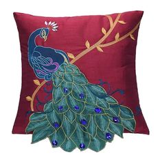 a decorative pillow with a peacock on it