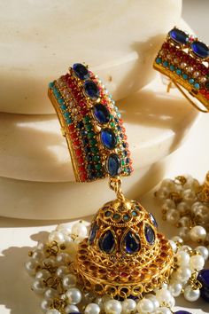 Elevate your style with our exquisite "Navdeep Jhumka Earrings." These heritage-inspired jhumka earrings are the perfect fusion of tradition and elegance. Crafted to perfection, they come in three primary color options, all in gold plating: ruby, blue, or gold, allowing you to choose the perfect match for your ensemble. Key Features: Color Options: Available in ruby, blue, or gold Dimensions: Approximately 3.5 inches Embellishments: Adorned with beautiful multi-color stones and embellishments Qu Three Primary Colors, Color Stones, Jhumka Earrings, Sapphire Blue, Blue Gold, Perfect Match, Blue Sapphire, Primary Colors, Color Options