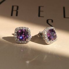 "✨💎 It gives you beautiful, attractive and outstanding jewelry experience ✨ * Everlasting Confidence * Wonderful Quality * Stay Shiny * Exquisite Fit Elevate Your Elegance: Amethyst Cushion Halo Stud Earrings Indulge in the allure of timeless sophistication with our Elegant Amethyst Cushion Halo Stud Earrings. Crafted with precision in solid 14K White Gold, these earrings are more than just jewelry; they're a statement of grace and refinement. Key Features: * Exquisite Amethyst Beauty: Adorning each earring is a magnificent 1 carat Cushion Cut Amethyst color  * Cubic Zirconia Stone, set within a radiant halo. Together, they create an impressive 2 carat total weight that will turn heads wherever you go. * Milgrain Filigree Finish: The back of these earrings features a delicate milgrain fil Luxury Earrings With Halo Setting For Gift, Luxury Purple Round Earrings, Anniversary Crystal Gemstone Earrings, Anniversary Crystal Earrings, Dazzling Earrings With Halo Setting For Gift, Luxury Silver Amethyst Earrings, Amethyst Earrings Fine Jewelry For Formal Occasions, Dazzling Halo Setting Earrings Gift, Formal Amethyst Gemstone Earrings