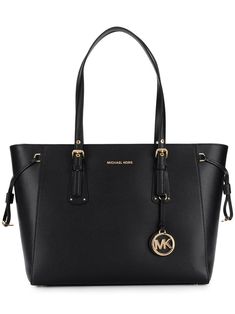 Combining elements of classic and contemporary design, Michael Michael Kors is the go-to label for clean-cut shapes and ultra-chic details. Case in point: this black leather Voyager tote. Equal parts polished and practical, the streamlined silhouette boasts a top zip fastening, a main internal compartment and multiple internal pockets for neat organization, plus delicate gold-tone hardware, a front logo plaque and a playful logo charm to finish. Swing it over your shoulder or slip it into the cr Sac Michael Kors, Michael Kors Tote Bags, Girly Bags, Fancy Bags, Iconic Bags, Purses Michael Kors, Handbags Michael Kors, Women Accessories Bags, Black Tote Bag