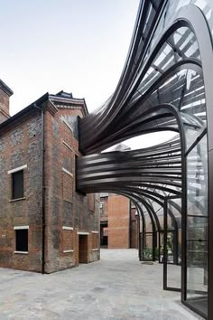 an outdoor area with a metal structure and brick buildings