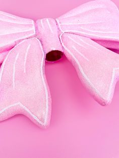 a pink bow on a pink background