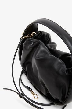 Black leather tote bag from Roger Vivier. The Viv' Choc hobo bag is made of nappa leather with a soft drape and can be carried by hand or crossbody with the removable shoulder strap. Measurements: L19 x H13.5 x W8 cmMade in Italy Leather Bucket Bag With Round Handle For On-the-go, Leather Shoulder Bag With Round Handle For On-the-go, Evening Shoulder Bag With Adjustable Strap And Round Handle, Chic Bucket Bag With Adjustable Strap And Round Handle, Leather Bucket Bag With Detachable Strap For Evening, Evening Bucket Hobo Bag With Removable Pouch, Versatile Soft Leather Evening Bucket Bag, Evening Bucket Hobo Bag With Detachable Handle, Faux Leather Top Handle Evening Bag