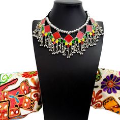 Summer is here! Celebrate with a colorful, playful, fun choker that compliments your wardrobe. Excellent quality, detailed ghungroo dangles, saturated vivid colors. Comfortable silky black cord tie, adjustable to the perfect fit for you. Shop chokers here: https://www.etsy.com/shop/boutiquebymaryam?section_id=23900841 Be sure to visit the rest of my shop here: https://www.etsy.com/shop/boutiquebymaryam Red Necklaces With Motifs For Gifts, Festive Multicolor Beaded Necklace With Latkans, Traditional Necklaces For Festivals, Traditional Necklaces For Festival Gifts, Traditional Festival Necklaces As Gifts, Bohemian Necklaces With Motifs For Gift, Bohemian Necklaces With Motifs As Gift, Multicolor Latkans Necklace For Festive Occasions, Multicolor Necklaces With Latkans For Festive Occasions