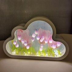 there is a cloud shaped tray with flowers in it