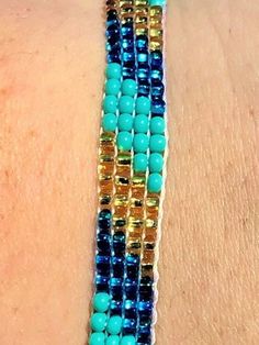 "Perfect for a pop of color! This turquoise \"skinny\" bracelet will charm your way through the day. Made using brilliant glass seed beads and premium nylon, these bohemian styled bracelets are dressed to impress and are a must-have every day accessory! Makes for a great birthday gift, Christmas gift, holiday gift, stocking stuffer, friendship bracelet and especially a \"just because\" gift for mom! Delicately handmade in Guatemala *Please note that all of our items are handcrafted and unique to Bohemian Blue Bracelets With Colorful Beads, Blue Bohemian Bracelets With Colorful Beads, Adjustable Turquoise Wrap Bracelet With Tiny Beads, Hand-strung Turquoise Beaded Bracelets For Summer, Turquoise Friendship Bracelets With Tiny Beads For Summer, Bohemian Blue Bracelets With Spacer Beads, Blue Bohemian Bracelets With Spacer Beads, Summer Friendship Bracelets With Tiny Turquoise Beads, Turquoise Friendship Bracelet With Tiny Beads