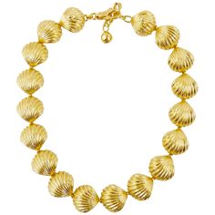 This Gianni Versace gold tone shell necklace is from the Spring Summer 1992 Tresor de la Mer collection which was inspired by the abundant treasures of the sea, reminiscent of Gianni's hometown in Calabria. The necklace is made up of 18 gold plated shells that all link together forming a short collar necklace. The back two shells have the famous medusa head detailing with a claw clasp to secure the necklace. This stunningly simple item will had a touch of the Mediterranean style to any outfit. W Simplistic Jewelry, Versace Necklace, Vintage Gold Necklace, Fruit Necklace, Vintage Choker Necklace, Claw Necklace, Versace Gold, Vintage Choker, Stone Choker