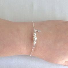 Sterling Silver Cross Bracelet, Baptism Bracelet, Baby Christening Bracelet, First Communion Gift, Confirmation GiftNow is available in 14K Gold Filled and 14K Rose Gold Filled.Specification. Chain and all components are Sterling Silver. Cross size 4.5 x 8.5mm. Pearl is Swarovski with size 6mm and 4mm. Comes in a satin pouch. Length includes pearl, jump ring and claspIMPORTANT:Usually jewellery in the pictures looks bigger than in reality.Please consider all given dimension and compare them to t Handmade Silver Bracelets For First Communion, Handmade Silver Rosary Bracelet For Wedding, Adjustable Cross Bracelets For Wedding, Adjustable Cross Bracelets For Weddings, Handmade Silver Rosary Bracelet For Baptism, Baptism Bracelet, Silver Cross Bracelet, White Pearl Jewelry, First Communion Gifts