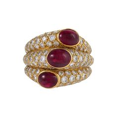 This glamorous ruby and diamond "Three Band" ring has unmistakable Cartier style and craftsmanship. Set among sparkling pavé-set diamonds, the triplet of cabochon rubies of superb color form a diagonal line across three fused bands that balance perfectly on the finger. Artist: Cartier, Paris Country: France Circa: 1990s Size: 6.5 (this ring may be resized, please contact us for further information) Materials: 140 Round brilliant-cut diamonds (approximate total weight 4.25 carats); 3 Oval cabocho Vintage Fine Jewelry, Ruby Diamond Rings, Contemporary Ring, Dome Ring, Ruby Jewelry, Domed Ring, Ruby Diamond, Cartier Ring, Ruby Ring