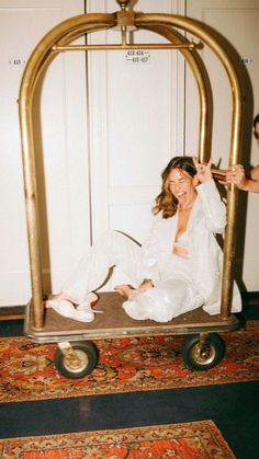 a woman sitting on top of a metal cart