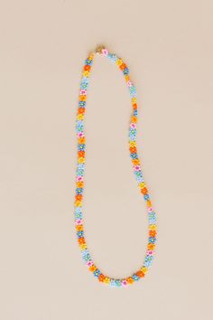 Nothing like a little daisy chain that lasts a lifetime. The Zara is hand beaded with so much love. One of our original necklaces, we always recommend Zara for a layered look, casual or dressed up, she's a perfect faux choker for everyday wear. Available in summer daisy: our combination of blue, pink, and yellow flowers with varying centers to create a bright poppy combination of flowers. - 3D Daisy chain necklace - 14k Gold fill lobster clasp - Handmade in Mexico - 17" Length 5mm width Beaded Flower Necklace For Summer Gifts, Summer Flower Beaded Necklaces, Summer Flower Necklace With Tiny Beads, Summer Flower Necklace With Tiny Round Beads, Spring Beach Beaded Necklaces With Round Beads, Trendy Summer Beaded Necklaces With Flower Shape, Colorful Flower-shaped Beaded Necklaces For Summer, Flower-shaped Colorful Beaded Necklaces For Summer, Trendy Flower-shaped Beaded Necklaces For Summer