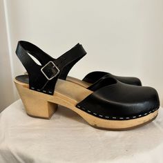 Swedish Hasbeens Leather Slingback Pumps, Black, Round-Toes, Block Heels With Platform, Straps & Buckle Closure At Ankles, 3" Heel. Materials: Leather And Wood Size: Eur 41/Us 10 Condition: Used - See Pictures For Details, Happy To Answer Any Questions! Chic Clogs With Ankle Strap And Buckle Closure, Chic Ankle Strap Clogs With Buckle Closure, Classic Black Mules With Buckle Closure, Chic Clogs With Ankle Strap And Removable Insole, Chic Ankle Strap Clogs With Removable Insole, Classic Black Slingback Mules, Black High Heel Slingback Sandals With Buckle, Spring Slingback Clogs With Heel Strap, Black High Heel Slingback Sandals With Buckle Closure