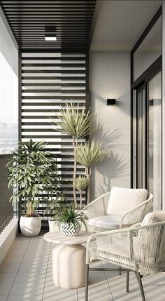 a balcony with two chairs and a table on the floor next to potted plants