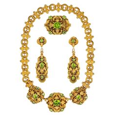 An early Victorian peridot and gold parure in the Knight pattern, the necklace consisting of three plaques each set with five cushion shape faceted peridots set in a stamped gold eclectic design surround, attached to a chain consisting of sixteen round links alternating with foliate design links in-between, the oval-shaped brooch set with five cushion shape faceted peridots on a matching eclectic design background and the earrings of similar design each set with three cushion and one pear-shape Sabyasachi Jewellery, Art Nouveau Pendant, The Knight, Peridot Necklace, Vintage Fine Jewelry, Yellow Gold Setting, Eclectic Design, Bespoke Jewellery, Victorian Jewelry