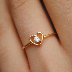 A pretty 0.07ct round brilliant diamond, set inside a heart silhouette, this ring is crafted in 14k solid gold and is a treat to the eyes and heart. * Diamond Wt. : 0.07 Cts * Color-Clarity Grade : H-I - Vs-Si * Gold - 14kt, 1.2 gms Solid Yellow Gold Find us on Instagram for exquisite designs: @abhikajewels Like us on Facebook: www.facebook.com/Abhikajewels Thank you for visiting our shop.. :) Heart Shape Ring Design, Heart Shape Ring Design Gold, Valentine's Day Single Diamond Ring In Fine Jewelry Style, Heart Ring With Single Diamond Round Cut As Gift, Fine Jewelry Heart Ring With Single Round Cut Diamond, 14k Gold Solitaire Heart Ring For Promise, 14k Gold Heart Ring With Single Diamond, Fine Jewelry Heart Ring With Single Diamond, Gold Heart Ring With Single Diamond For Gift