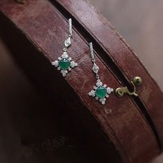 This danity green jade dangle earrings is very stunning and delicate. It's inspired by the shape of snowflake, and the vivid green jade make it unique and special among the snowflake earrings. It's a best gift idea for birthday gifts, engagement gifts, bridesmaid gifts and anniversary gifts. Features: - Made to Order - Material: 925 Sterling Silver with 14K Gold Plated - Color: White Gold - Stone: Natural Green Jade & CZ - Ready to ship in 8 to 12 business days - Each order will be beautifully packaged for gift giving in a jewelry box. Thank you for your time on our store. Hope you like our designs. Find out more about us on: https://www.etsy.com/hk-en/shop/SusannaJewelryDesignReturn and Refund: We don't accept return and refund for solid gold orders and custom orders except for quality pr Luxury Silver Jade Earrings, Fine Jewelry Green Drop Earrings, Green Fine Jewelry Drop Earrings, Green Crystal Earrings For Pierced Ears, Elegant Green Crystal Earrings For Pierced Ears, Elegant Round Emerald Earrings, Emerald Drop Crystal Earrings, Green Fine Jewelry Earrings For Party, Vintage Style Emerald Drop Earrings