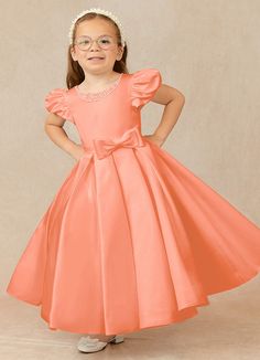 Have your flower girl dressed to impress your friends and family while she wears our matte satin little ballgown, Jewel. Her neckline is jeweled with hand sewn beading, puff sleeves, and a beautiful bow belt that sits atop a full box-pleat tea length skirt. We have matching pearls at the sleeves and a removable back bow. Satin Princess Dress With Fitted Bodice, Princess Style Satin Ball Gown For Pageants, Princess Style Satin First Communion Dress, Satin Princess Dress With Fitted Bodice For Pageant, Elegant Solid Color Princess Dress For Dress-up, Satin Princess Dress For Dress-up, Princess Satin Bridesmaid Dress, Satin Princess Bridesmaid Dress, Princess Style Satin Bridesmaid Dress