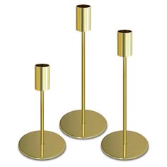 three gold candlesticks are standing next to each other