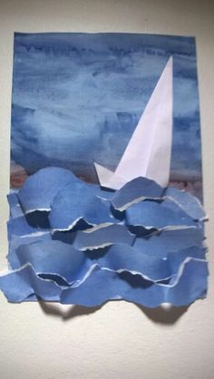 a paper boat floating on top of the ocean