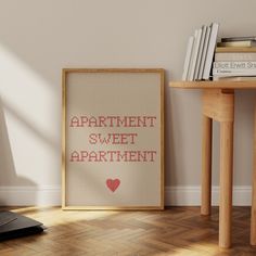 an apartment sweet apartment cross stitch pattern is displayed in front of a table with books