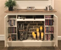 a book shelf with books and candles on it