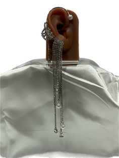 The Stellar Waterfall Ear Cuff is an exquisite piece that cascades down the ear with fluidity. Set in fine silver, it features rows of meticulously placed sparkling gems. At intervals, lustrous pearls punctuate the design, adding an element of classic elegance to the modern silhouette. This ear cuff is designed for the fashion connoisseur, a statement piece that marries the timeless allure of pearls with the daring sparkle of a starlit galaxy. Elegant Metal Single Ear Cuff, Elegant Metal Ear Cuff For Formal Events, Elegant Metal Ear Cuff For Formal Occasions, Elegant Metal Ear Cuff For Party, Silver Cubic Zirconia Ear Cuff For Party, Elegant Metal Ear Cuff For Evening, Elegant Metal Ear Cuff, Elegant Silver Jewelry For Party, Silver Teardrop Ear Cuff