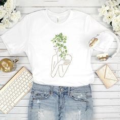 floral shirt, t shirts for women, aesthetic shirt, gifts for her, trendy shirts, teen girl shirt, botanical shirt 👕 Wonderful t-shirt will create a fascinating look! Perfect gift for girls and women. This floral t shirt will become the favorite part of your outfit! ►CLASSIC FIT Our unisex T-shirts are true to size. Look amazing with our graphic tee! Due to the comfortable fitting, the floral print T-shirt will favorably accentuate your figure. Great for sports, outdoor activities, etc. Made from soft and breathable material that is pleasant to the skin! ►COOL GIFT Give your family members or friends a floral shirt, impress them! The flower T-shirt is a unique gift for any occasion: * Birthday * Christmas * Graduation * Anniversary * Halloween, etc. ►DETAILS * Unisex * For kids and adults Aesthetic Graphic Print Tops For Summer, Trendy Short Sleeve Shirt With Plant Print, Aesthetic Summer Tops With Letter Print, Aesthetic Letter Print Summer Tops, Summer Aesthetic Short Sleeve T-shirt, Trendy Crew Neck Shirt With Plant Print, White Aesthetic Summer Tops, Aesthetic Graphic Print Tops For Spring, Aesthetic Relaxed Fit T-shirt For Summer