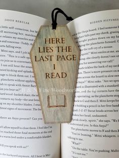 there lies the last page i read bookmark hanging on an open book's pages