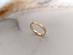 "A gorgeous hand stamped, 9ct gold botanical ring with a secret message inside. You can leave your ring plain inside or add a personalised message, making this an excellent gift. We will use our discretion when selecting the font size for the personalisation inside the ring depending on the length of the message for the best fit (1mm or 1.5mm font).  Please note if selecting white gold, it is natural white gold and will not be rhodium plated. Your jewellery will arrive beautifully presented in a Wedding Yellow Gold Stamped Jewelry, Gold Engraved Promise Ring With Birth Flower, Stamped 14k Gold Rings For Wedding, 14k Gold Stamped Wedding Rings, Recycled Gold Engraved Ring With Round Band, Minimalist Stamped Yellow Gold Engraved Ring, Minimalist Yellow Gold Stamped Engraved Ring, Minimalist Yellow Gold Engraved Stamped Ring, Engraved Recycled Gold Ring For Anniversary