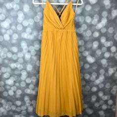 Nwt Saints And Secrets Mustard Yellow Chiffon Pleated Midi Dress. Wrap Style V Neck Top With Adjustable Straps That Cross In The Back And A Line Pleated Bottom Designed To Hit Between Mid Calf And Ankle. Hidden Zipper Closure On The Side. Size Xs. Length Approximately 44in (Straps Are Adjustable) Yellow Chiffon V-neck Maxi Dress, Spring Yellow Chiffon Midi Dress, Fitted Yellow Pleated Midi Dress, Yellow Flowy Sleeveless Chiffon Dress, Flowy Sleeveless Yellow Chiffon Dress, Yellow V-neck Chiffon Maxi Dress, Elegant Yellow Pleated Maxi Dress, Yellow V-neck Chiffon Beach Dress, Yellow V-neck Chiffon Dress For Party