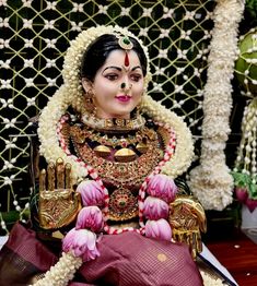 a statue of a woman sitting on top of a table