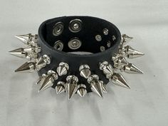 Three Row 1/2" Spike Bracelet Genuine Cowhide 7oz Weight Leather Bracelet Snap Bracelet 7oz Cowhide Leather Military Grade Rust Protected Spikes SIZE:    ALL BRACELET ARE 9"-9 1/2" LONG.  FITS 7"-9"  WRISTS Adjustable Rocker Style Bracelets For Parties, Alternative Style Rivet Bracelets For Festivals, Adjustable Rocker Bracelets For Party, Alternative Style Rivets Bracelets For Festival, Alternative Style Rivets Bracelet For Festivals, Rock Style Jewelry With Rivets For Party, Adjustable Rocker Bracelets For Parties, Alternative Style Bracelets With Rivets For Concert, Adjustable Rocker Style Bracelets For Concerts