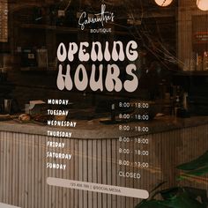 an open hours sign in the window of a restaurant