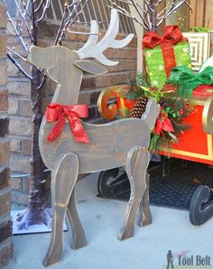 a wooden reindeer with red bows on its antlers