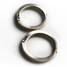 two metal rings with the words truth and truth written in black ink on white background